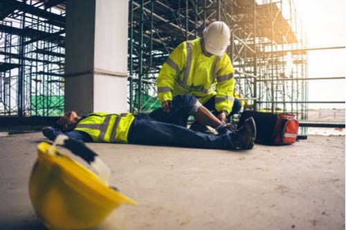 Work-related injuries in Naples, construction worker helping hurt coworker