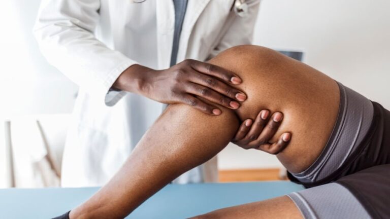 Doctor Examining a Knee of a Woman During an Appointment.