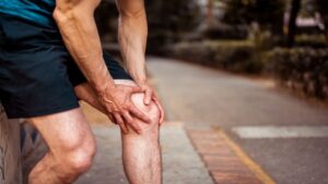 Athlete Holds on to His Knee as He Feels Muscle Strain
