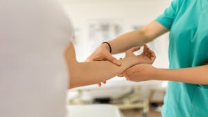 Woman Suffering from Carpal Tunnel Visits a Chiropractor for Treatment
